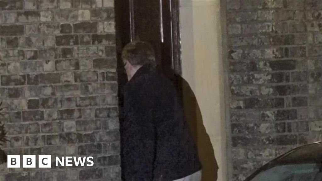 Peter Mandelson arriving at home after being released on bail